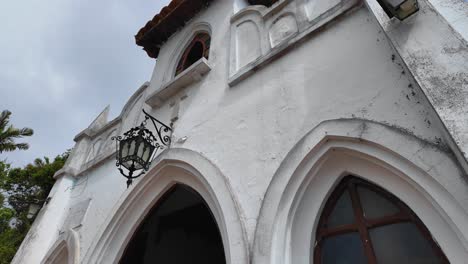 antique wrought iron lantern lamp adorns historic church facade, timeless beauty