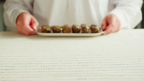 serving stuffed grape leaves (dolma)