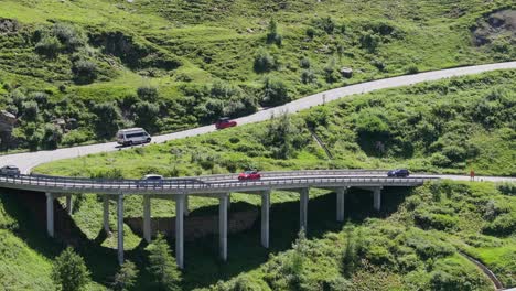 drone glides forward along austria’s famous grossglockner road, summer traffic