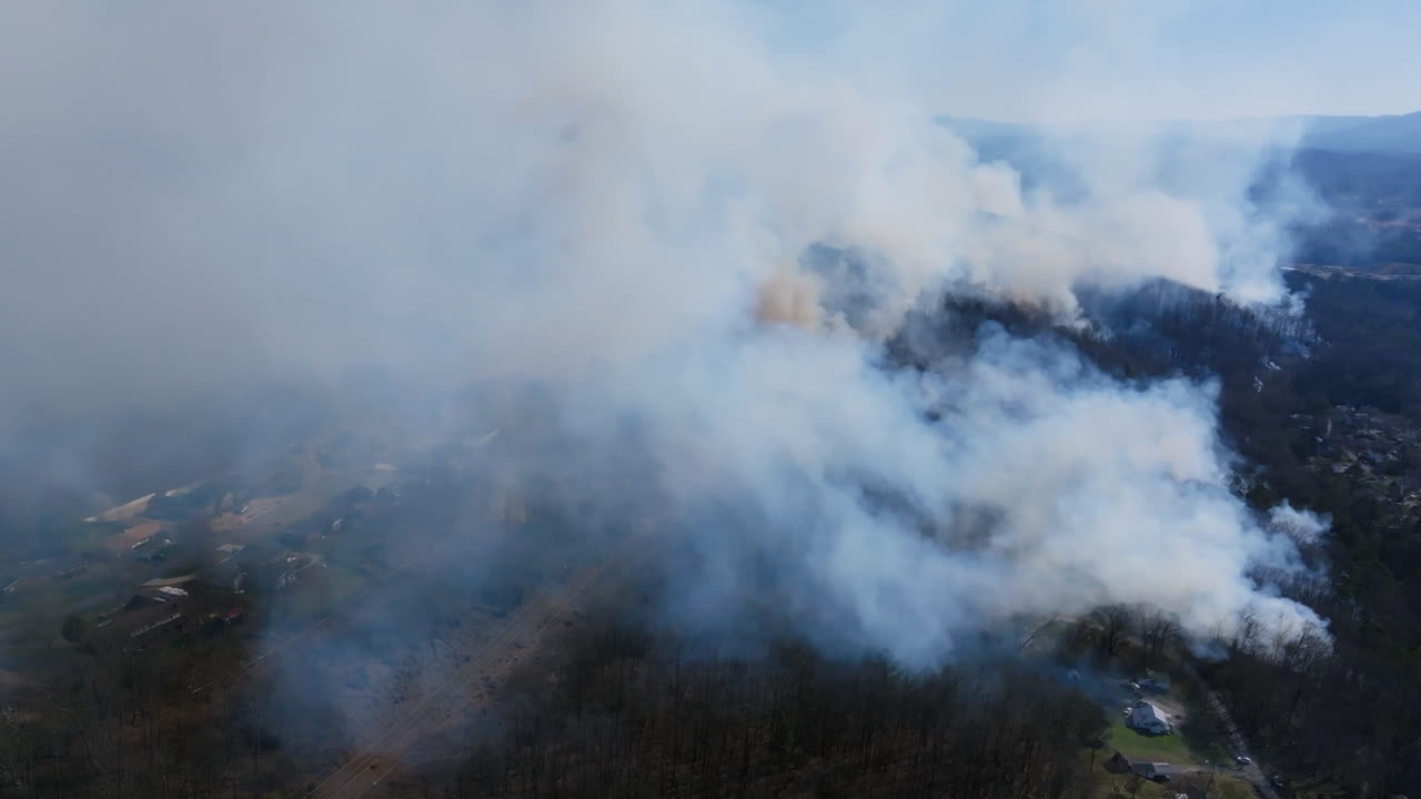 Aerial drone footage flying around the heavy smoke of a wildfire in Rossville, Georgia.