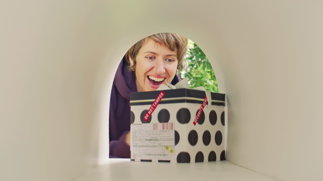 Cheerful Woman Clapping Hands while Retrieving Gift Box from Mailbox