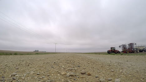 farm tractor and seeding equipment after work at the field - ground level gopro shot