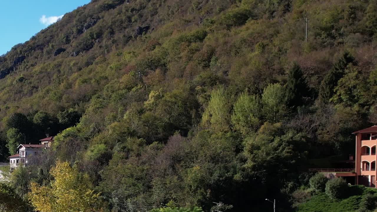 Scenic aerial view of the Italian Alps surrounded by lush greenery