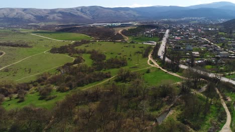 aerial view of a rural valley with village and mountains