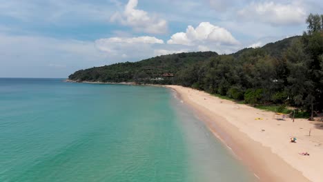 an aerial drone shot of the long stretch of white sand in nai thon beach located in phuket island, in the south of thailand