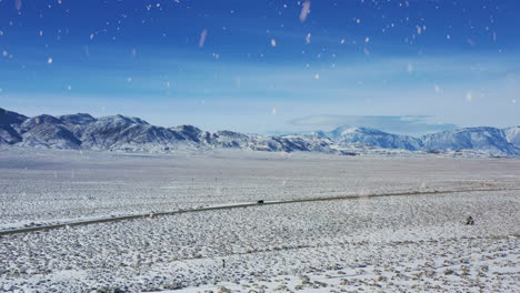 beautiful country road and winter desert during snowfall, aerial drone view