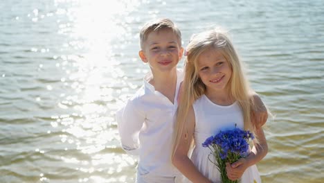 Boy Gives Flowers to Girl Happy Children Romantic Gift to Little Girl Brother and Sister Boy Gives Flowers to Girl Happy Children Romantic Gift to Little Girl Brother and Sister