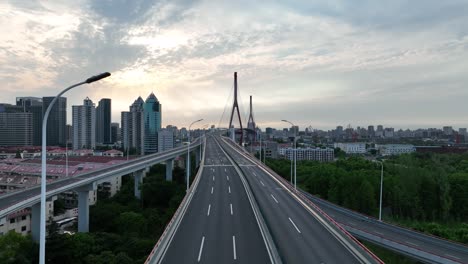 drone aerial view of traffic and highway in the city during sunset