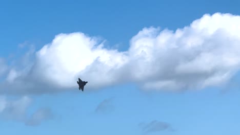 an f-22 raptor performs dynamic aerial maneuvers against a bright blue sky during the avalon airshow in geelong, australia