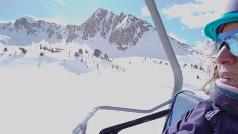 A-close-up-shot-of-a-woman-on-a-chairlift-in-a-clear-and-sunny-day