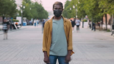 man wearing mask in city street