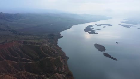 breathtaking view of mountain ridge and river in foggy weather