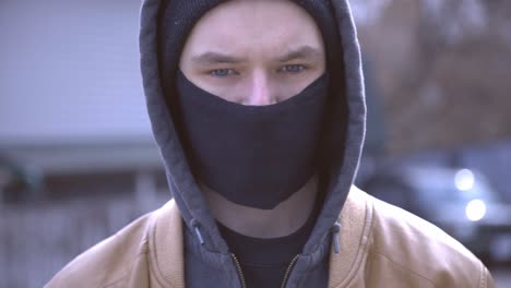 young caucasian man wearing a fabric facemask