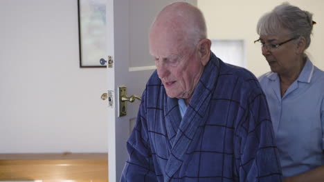 elderly man assisted by nurse