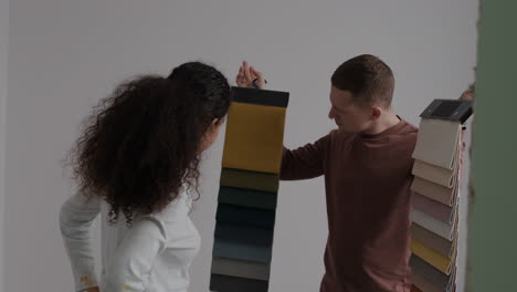 couple choosing fabric swatches for home renovation
