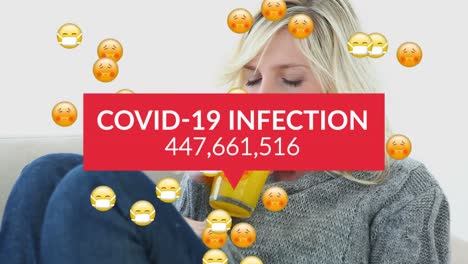 Animation-of-falling-covid-19-data-and-falling-sick-emoji-over-sick-caucasian-woman