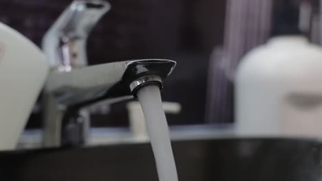 water running from a faucet into a sink