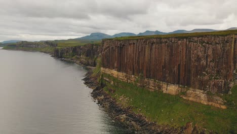 flying along scottish coast, near kilt rock waterfall on isle of skye, scotland, united kingdom