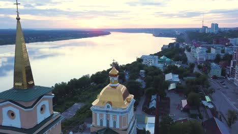 aerial view of a church and city at sunrise/sunset