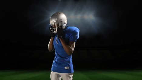 professional american football player standing in front of a sports stadium