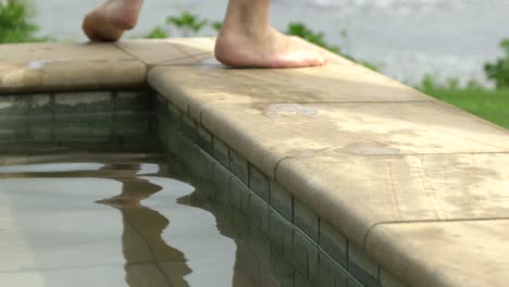 feet walking left with water reflection slow motion