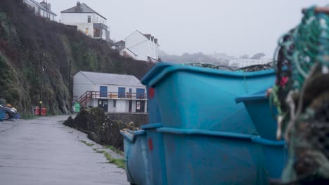 Mevagissey-Harbour-waterfront-promenade-on-a-typical-overcast-day-in-Cornwall,-England,-UK-Handheld-pan-left-to-right