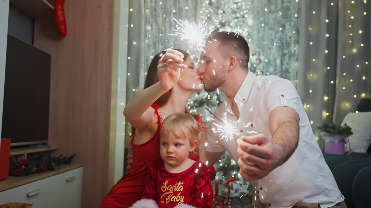 Festive family moment capturing parents and young daughter bonding with sparkling light from holiday sparklers, sharing joyful Christmas eve warmth inside decorated living room