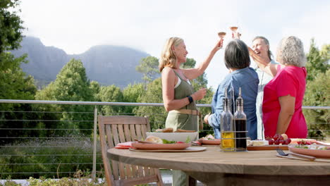 senior diverse group enjoys a meal outdoors, with copy space