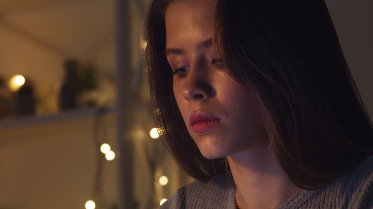 Young Woman Looking Down in a Cozy Room