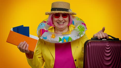 traveler tourist senior woman granny celebrating, holding passport tickets, luggage, summer vacation