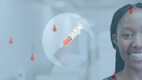 animation of blood drops and syringe over african american female doctor in hospital