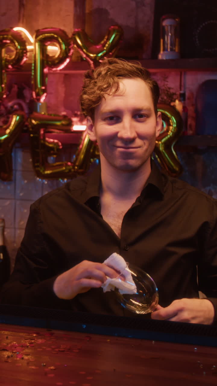 Bartender cleaning a wine glass at a party