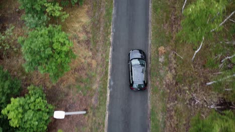 Black-car-driving-on-a-road