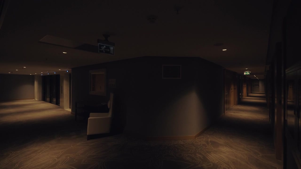 A steadicam shot of a dark hotel hallway