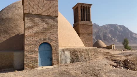 water reservoir in desert region the brick building with clay dome in iran desert area mountain landscape in background in a clean blue sky weather in summer in yazd windcatcher to fresh ventilation