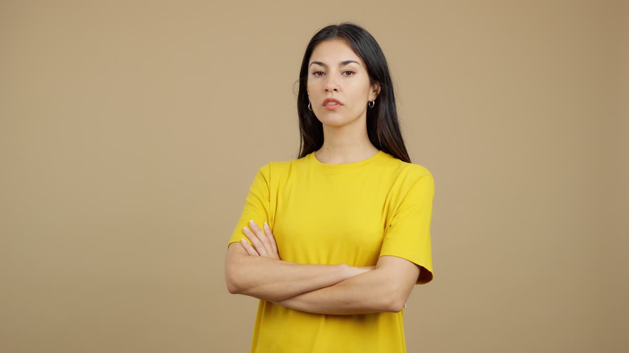 Young Woman in Yellow T-shirt with Arms Crossed