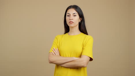 young woman in yellow t-shirt with arms crossed