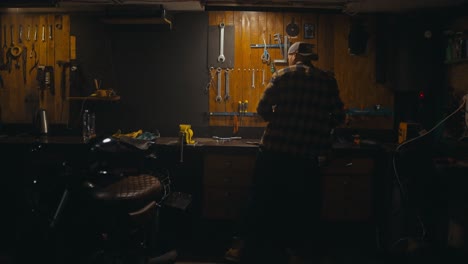 rear view of a confident mechanic working on a workbench among many tools in his workshop