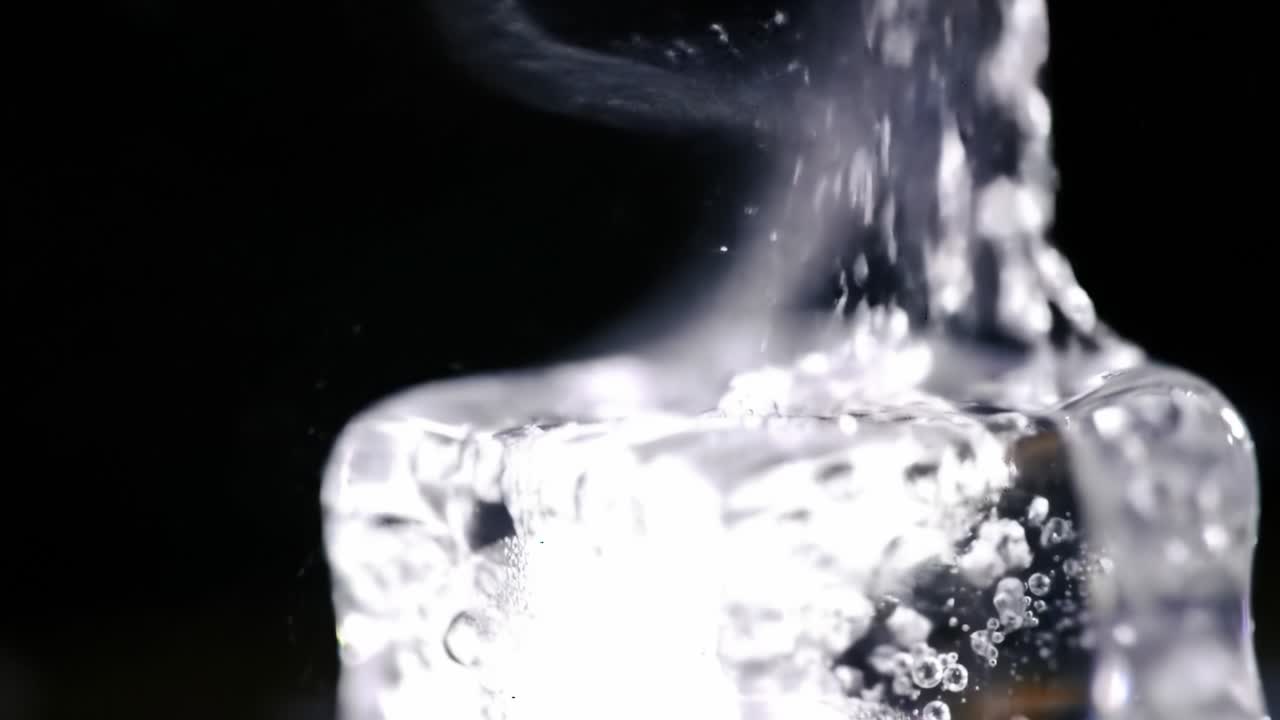 Captivating Close-Up of Ice Melting with Captured Air Bubbles and Intriguing Steam Emanating in a High-Contrast Black Background