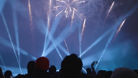 Silhouettes and cell phones capture the fireworks finale