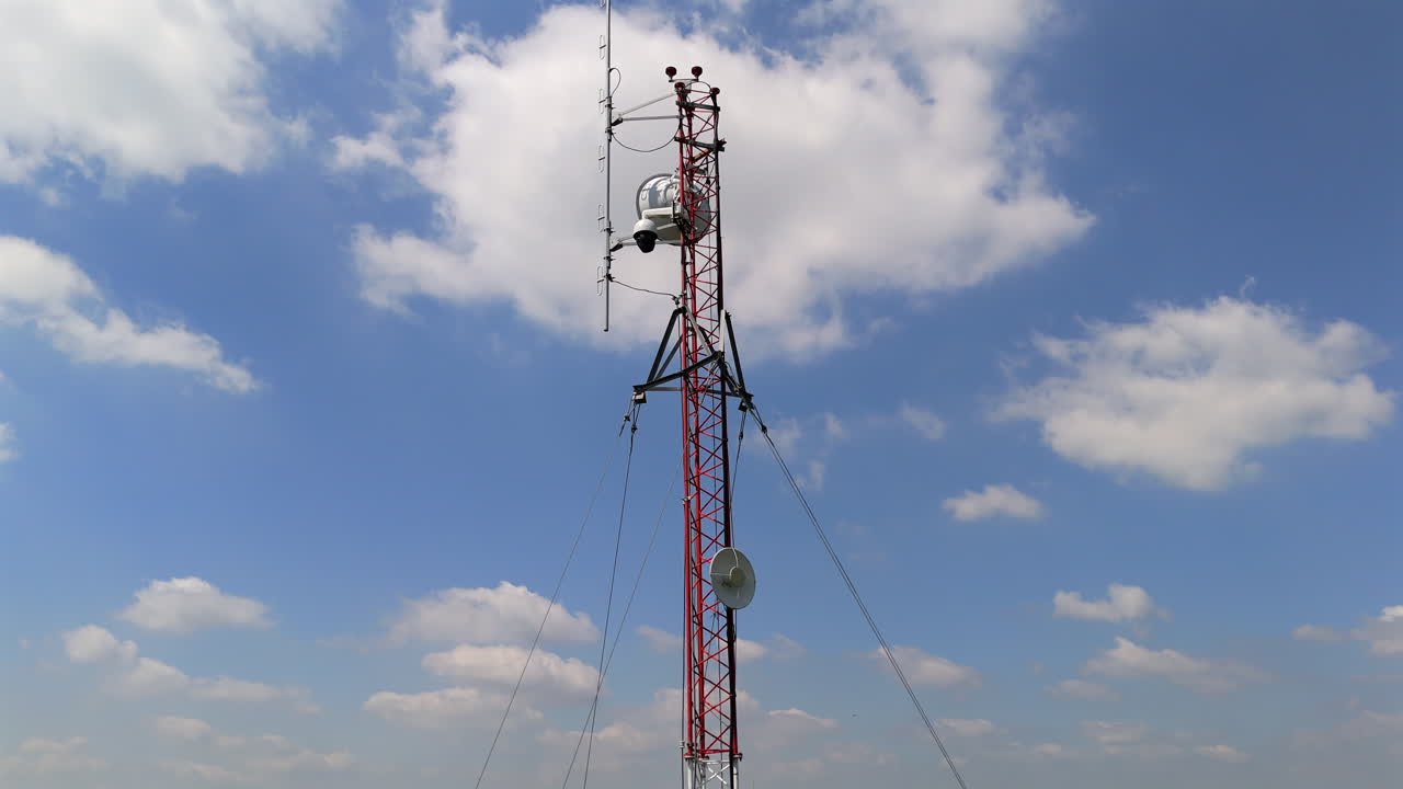 Capturing the towering communication structure against a dramatic blue sky.