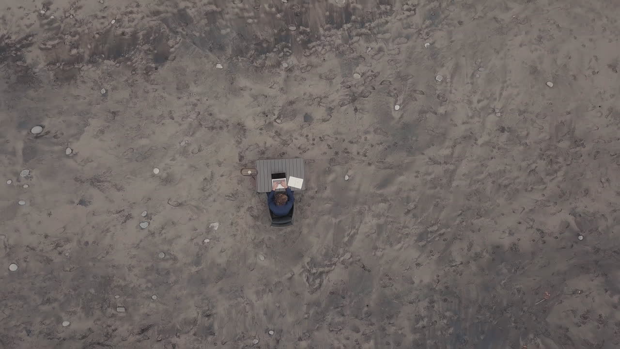 Top-View Of Man Working On Isolated Beach