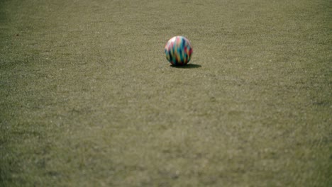 a young boy pass the ball through the field