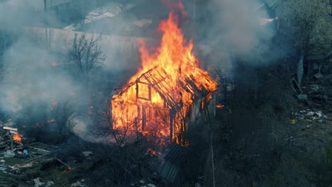 house in fire loop. seamless loopable footage of the burning wooden house