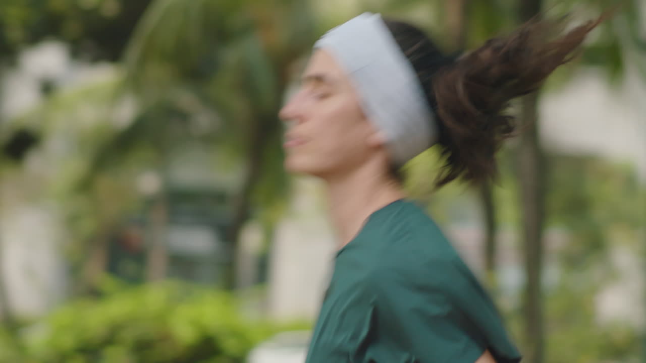 Woman Jogging along City Street