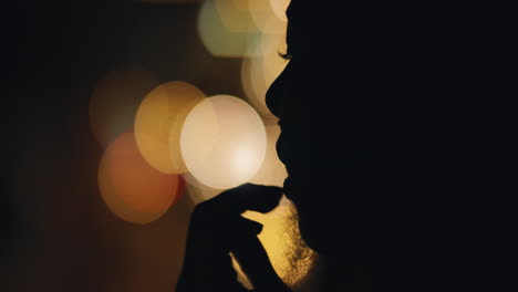 beautiful-silhouette-of-woman-blowing-kiss-with-bokeh-lights-in-background