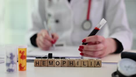 medical professional with blood sample and hemophilia blocks