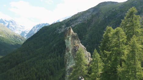 aerial: rocky peak in the swiss alps during the day near arolla's blue lake in val d'herens, canton of valais, switzerland, orbit drone shot