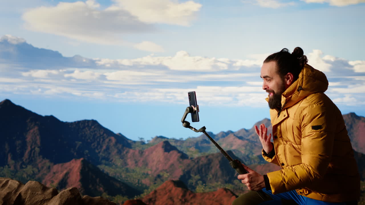Influencer recording a video in the mountains sharing his outdoor journey