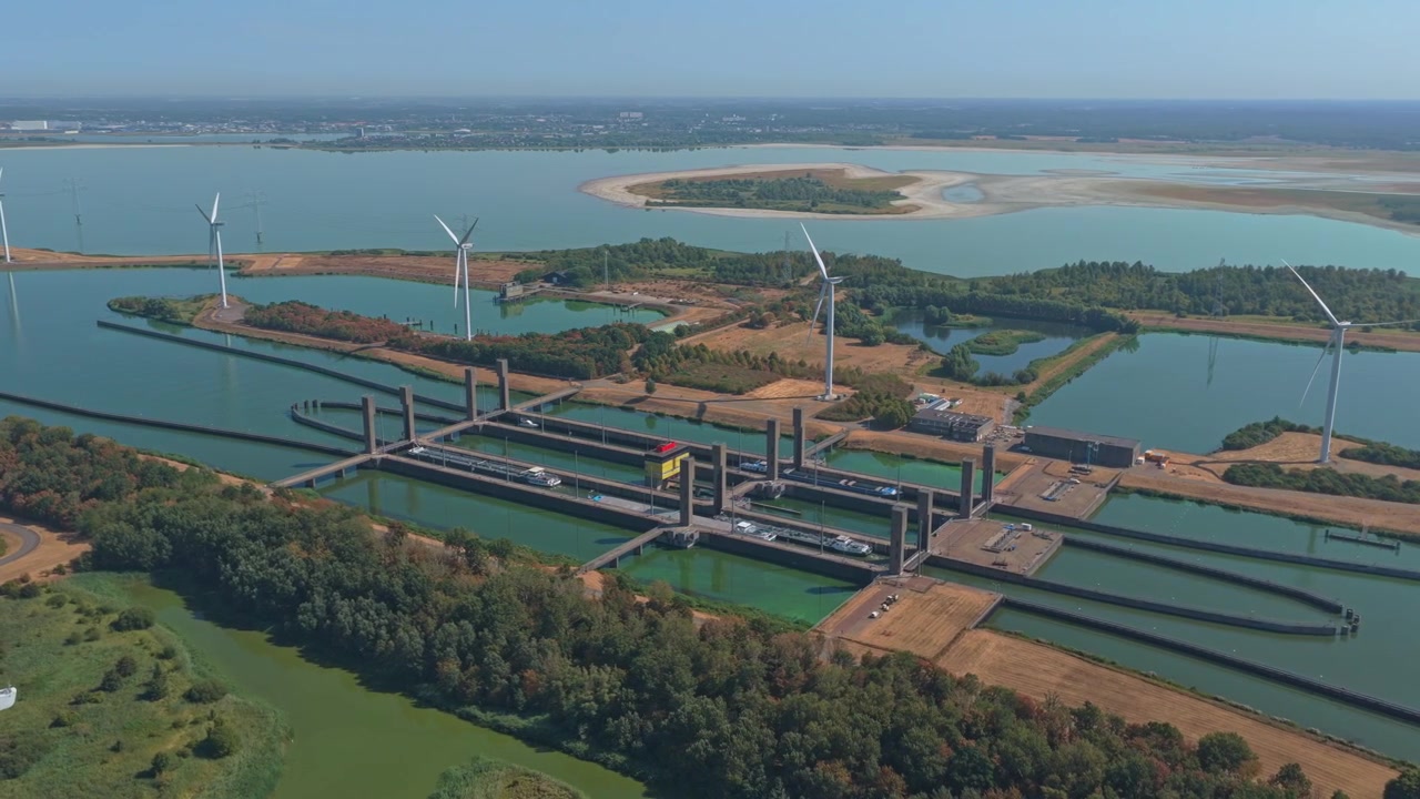 Aerial View of Industrial Canal Lock System with Wind Turbines